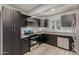 Modern kitchen with stainless steel appliances and dark cabinetry at 1022 E Mariposa St, Phoenix, AZ 85014