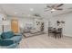 Open living room and dining area with light wood floors and ceiling fans at 1022 E Mariposa St, Phoenix, AZ 85014