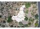 An aerial view of the home, mature landscape and pool at 10567 E Mark Ln, Scottsdale, AZ 85262