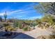 A luxurious backyard pool and desert landscape creates a perfect oasis for relaxation and entertainment at 10567 E Mark Ln, Scottsdale, AZ 85262