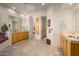 Bright bathroom featuring dual vanities, flagstone flooring, and decorative accents at 10567 E Mark Ln, Scottsdale, AZ 85262