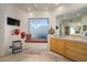 Bright bathroom with a view, decorative accents, and a stylish vanity with cabinets at 10567 E Mark Ln, Scottsdale, AZ 85262