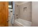 Elegant bathroom featuring a modern soaking tub and shower with light tile surround at 10567 E Mark Ln, Scottsdale, AZ 85262