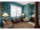 A sitting area in the bedroom featuring tropical wallpaper, natural light, and a bench at 10567 E Mark Ln, Scottsdale, AZ 85262