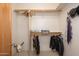 Well-organized walk-in closet with ample hanging space and storage shelves at 10567 E Mark Ln, Scottsdale, AZ 85262