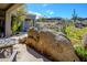 Outdoor stone fire feature with seating area, desert plants and mountain views create relaxing backyard at 10567 E Mark Ln, Scottsdale, AZ 85262