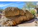 An outdoor rock fire feature creates a warm desert oasis in this Arizona backyard at 10567 E Mark Ln, Scottsdale, AZ 85262