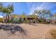 Home exterior featuring brick paver driveway, stone accents, and desert landscaping, offering inviting curb appeal at 10567 E Mark Ln, Scottsdale, AZ 85262