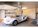 Spacious garage featuring built-in cabinets and a classic car at 10567 E Mark Ln, Scottsdale, AZ 85262