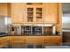 Close-up of a kitchen with stainless steel backsplash, granite countertops, and wood cabinets at 10567 E Mark Ln, Scottsdale, AZ 85262