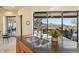 Modern kitchen featuring granite countertops and stunning views of the desert landscape at 10567 E Mark Ln, Scottsdale, AZ 85262