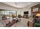 Inviting living room featuring a stone fireplace and panoramic views of the desert landscape at 10567 E Mark Ln, Scottsdale, AZ 85262