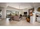 Spacious living room featuring stone floors, a comfortable seating area, and an abundance of natural light at 10567 E Mark Ln, Scottsdale, AZ 85262