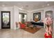 Living room featuring natural light, stone floors, and a desert landscape view at 10567 E Mark Ln, Scottsdale, AZ 85262