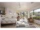 Bright main bedroom with sitting area and outside views through the large glass door at 10567 E Mark Ln, Scottsdale, AZ 85262