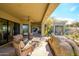 Covered outdoor patio with kitchen, bar area and cozy lounge seating perfect for entertaining at 10567 E Mark Ln, Scottsdale, AZ 85262