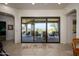 Transition to the outdoor patio through large glass doors, merging indoor and outdoor spaces at 10567 E Mark Ln, Scottsdale, AZ 85262