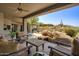 Comfortable outdoor patio with desert landscaping, fireplace, lounge seating and beautiful views at 10567 E Mark Ln, Scottsdale, AZ 85262