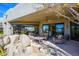 Inviting covered patio with comfortable seating and views of the desert landscape at 10567 E Mark Ln, Scottsdale, AZ 85262