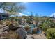 Inviting backyard pool with lush desert landscaping, ideal for enjoying warm sunny days at 10567 E Mark Ln, Scottsdale, AZ 85262