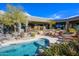 Stunning backyard pool with rock features, steps, desert landscaping, and patio seating at 10567 E Mark Ln, Scottsdale, AZ 85262