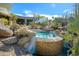 Beautiful backyard pool with rock features and desert landscaping, ideal for outdoor living at 10567 E Mark Ln, Scottsdale, AZ 85262