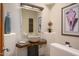 Unique powder room showcasing a stone vessel sink and rustic wood counter at 10567 E Mark Ln, Scottsdale, AZ 85262