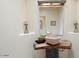 Unique powder room showcasing a stone vessel sink and rustic wood counter at 10567 E Mark Ln, Scottsdale, AZ 85262