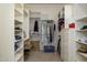 Bright walk-in closet with custom shelving, drawers, and hanging space at 10567 E Mark Ln, Scottsdale, AZ 85262