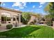 Landscaped backyard with lush green lawn and patio at 10638 E Blanche Dr, Scottsdale, AZ 85255