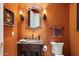 Elegant bathroom with dark vanity and decorative mirror at 10638 E Blanche Dr, Scottsdale, AZ 85255