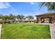 Community pool and expansive grassy area with covered patio at 10638 E Blanche Dr, Scottsdale, AZ 85255