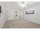 Simple bedroom with carpet, ceiling fan, and Hollywood-themed art at 10826 N 115Th Ave, Youngtown, AZ 85363