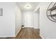 Clean entryway with wood-look floors and a potted plant at 10826 N 115Th Ave, Youngtown, AZ 85363