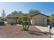 Ranch-style home with gravel landscaping and a two-car garage at 10826 N 115Th Ave, Youngtown, AZ 85363