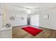 Living room boasts a ceiling fan, red area rug, and neutral walls at 10826 N 115Th Ave, Youngtown, AZ 85363