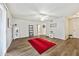 Bright living room with wood-look floors and a red rug at 10826 N 115Th Ave, Youngtown, AZ 85363