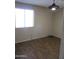 Spacious bedroom featuring wood-look floors and large window at 1305 W Isabella Ave, Mesa, AZ 85202