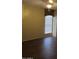 Well-lit bedroom with dark wood-look floors and window blinds at 1305 W Isabella Ave, Mesa, AZ 85202