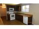 White appliances and wood cabinetry in this well-lit kitchen at 1305 W Isabella Ave, Mesa, AZ 85202