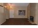 Living room with wood-look floors, fireplace, and door to exterior at 1305 W Isabella Ave, Mesa, AZ 85202