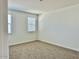 Bright bedroom with neutral carpeting and window blinds at 15371 W Desert Hollow Dr, Surprise, AZ 85387