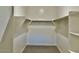 Spacious walk-in closet with double hanging rods and shelving at 15371 W Desert Hollow Dr, Surprise, AZ 85387