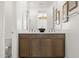 Modern bathroom with double vanity and wood cabinets at 15374 W Hackamore Dr, Surprise, AZ 85387