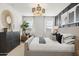 Elegant bedroom with gray upholstered bed and dark wood dresser at 15374 W Hackamore Dr, Surprise, AZ 85387