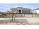 Single-story house with gray exterior, black fence, and small front yard at 15374 W Hackamore Dr, Surprise, AZ 85387