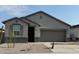 Single-story home with gray exterior, two-car garage, and small front yard at 15382 W Hackamore Dr, Surprise, AZ 85387