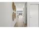 Bright hallway with wood floors and modern wall art leading to the living area at 15382 W Hackamore Dr, Surprise, AZ 85387