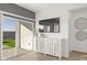 Living area featuring a modern media console, sliding glass doors, and wood flooring at 15382 W Hackamore Dr, Surprise, AZ 85387