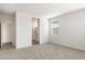 Primary bedroom with carpet and access to the bathroom at 15429 W Hackamore Dr, Surprise, AZ 85387